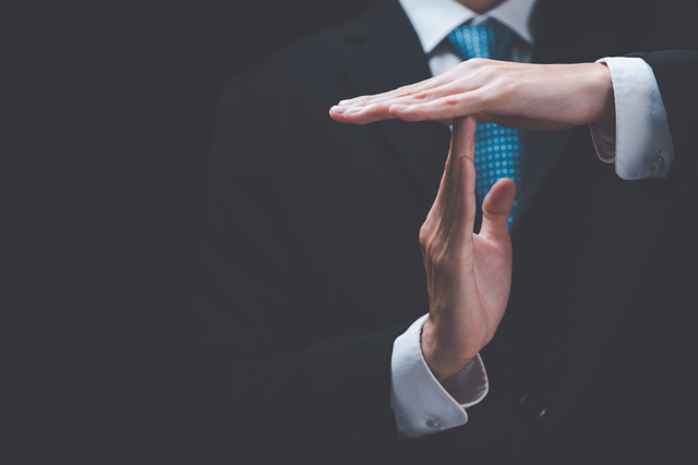 Businessman showing hand sign ,pause or request a break ,time ou